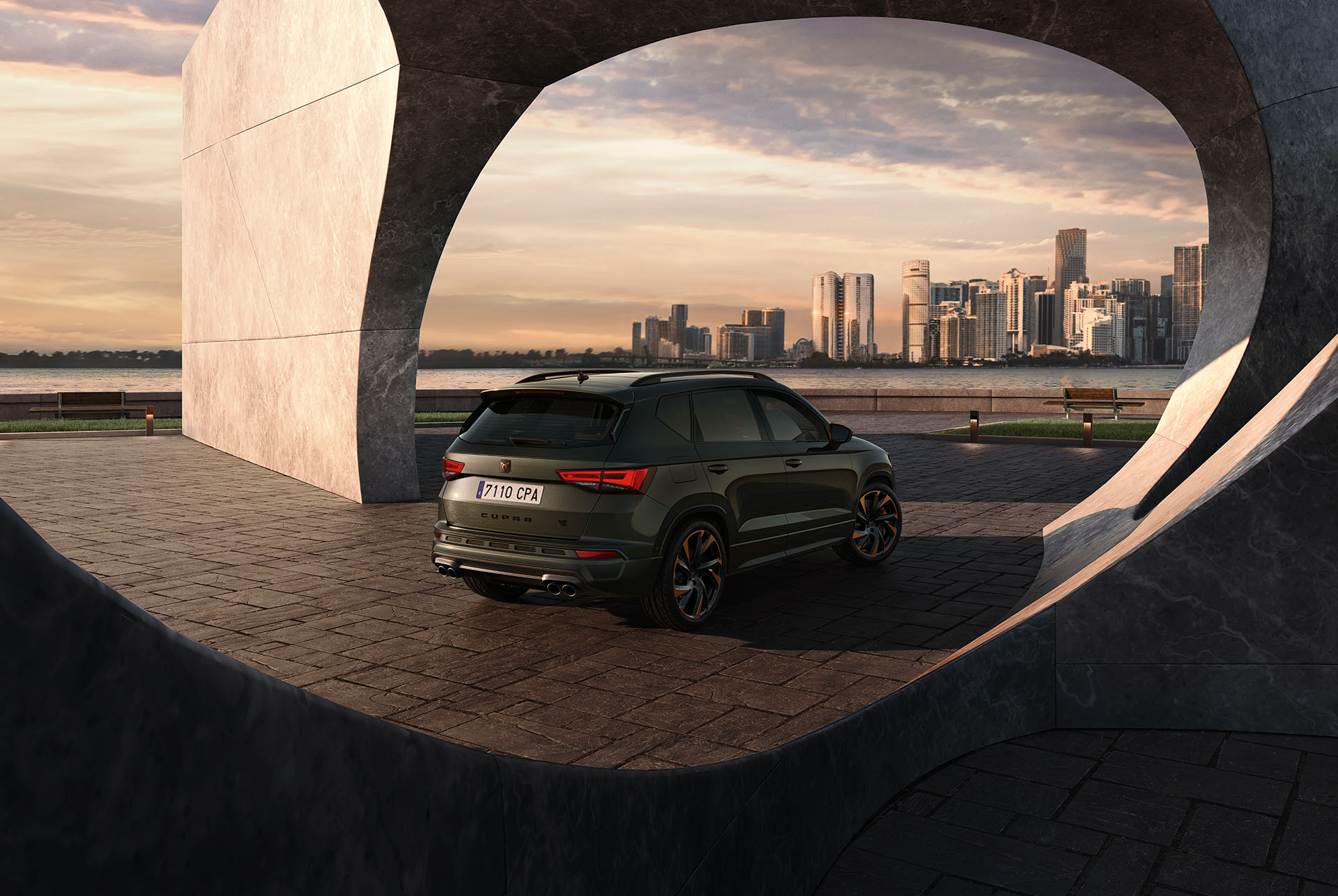 Rear view of the CUPRA Ateca Tribe Edition against a cityscape backdrop, highlighting its bolder design, 300hp engine.